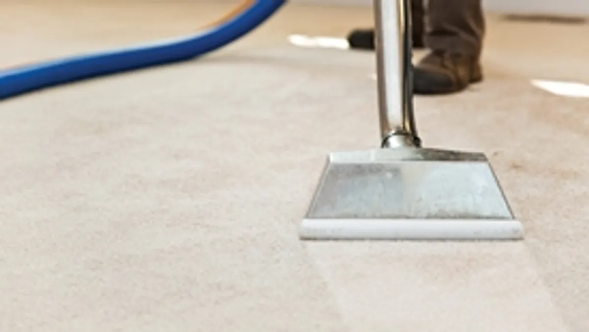 Carpet cleaning wand head gliding over a light carpet during hot-water extraction, Akron, OH.